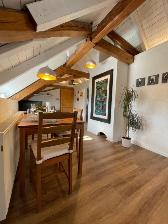 a dining room with a wooden table and chairs at Ferienwohnung Schneider Friedrichshafen in Friedrichshafen