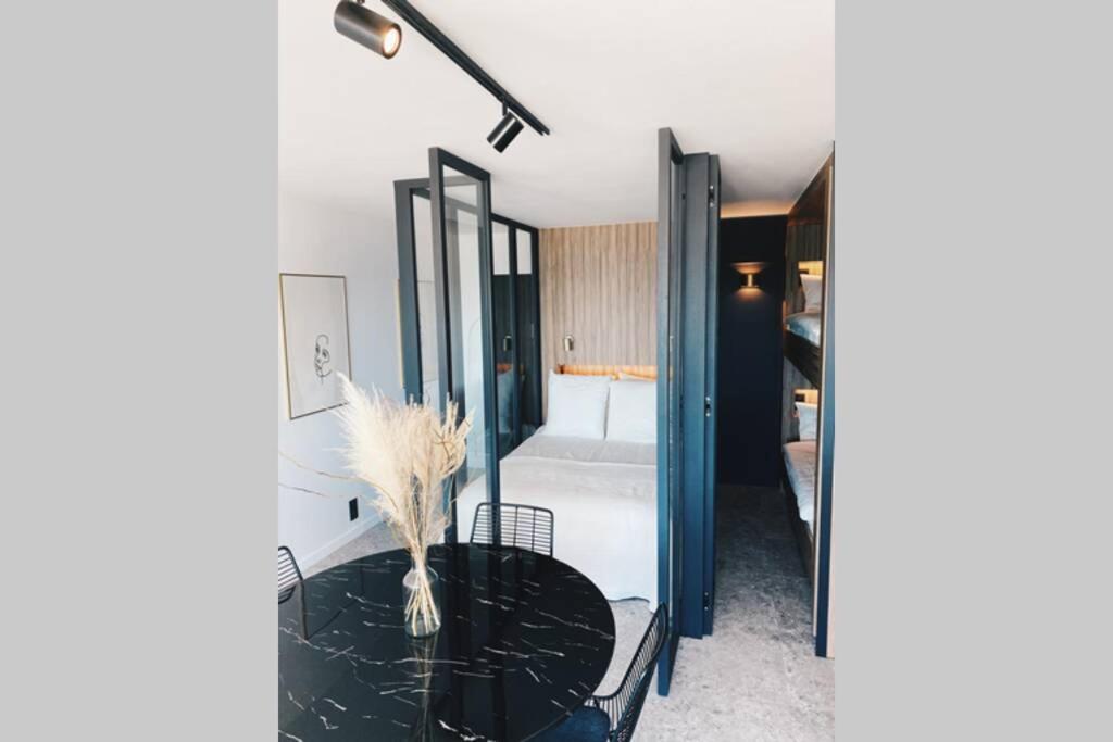 a bathroom with a black table and a tub at Wonderful architect designed flat with sea view in Ostend
