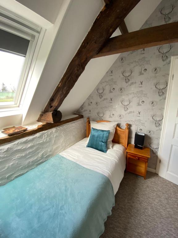 Postel nebo postele na pokoji v ubytování La Petite Maison - No 4 La Relierie