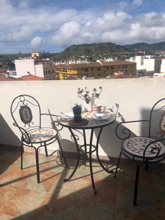 a table and chairs sitting on a balcony at Atico La Laguna con terraza y vistas in Las Lagunas
