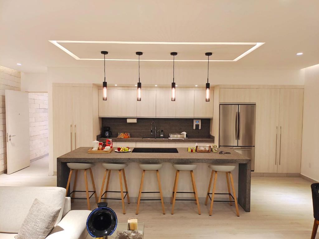 a kitchen with a stove top oven and a counter top at 1st Luxury Warehouse in Cancún