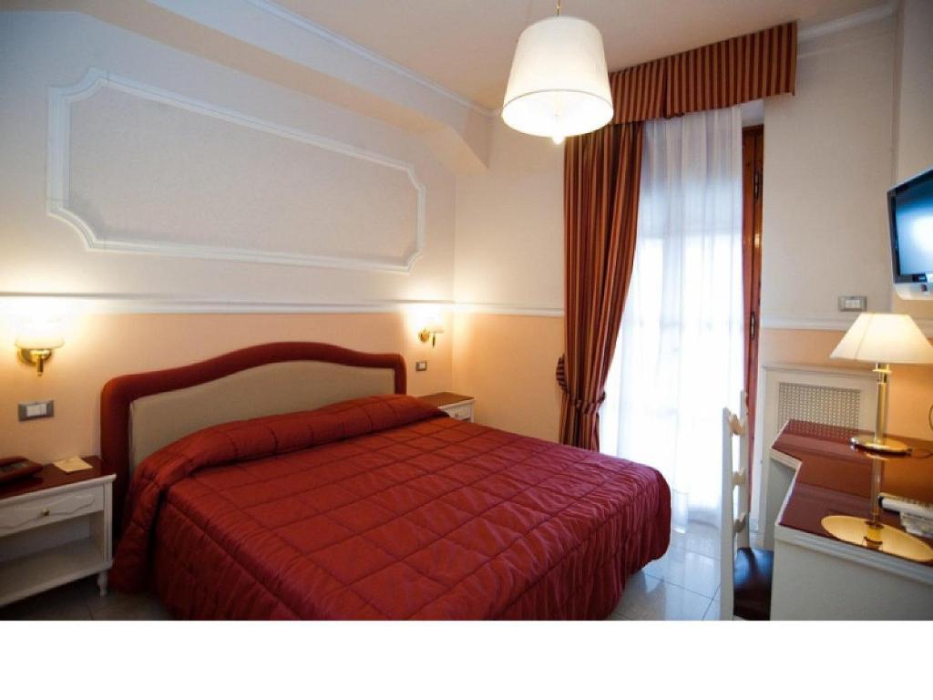 Postel nebo postele na pokoji v ubytování Hotel Gran Duca