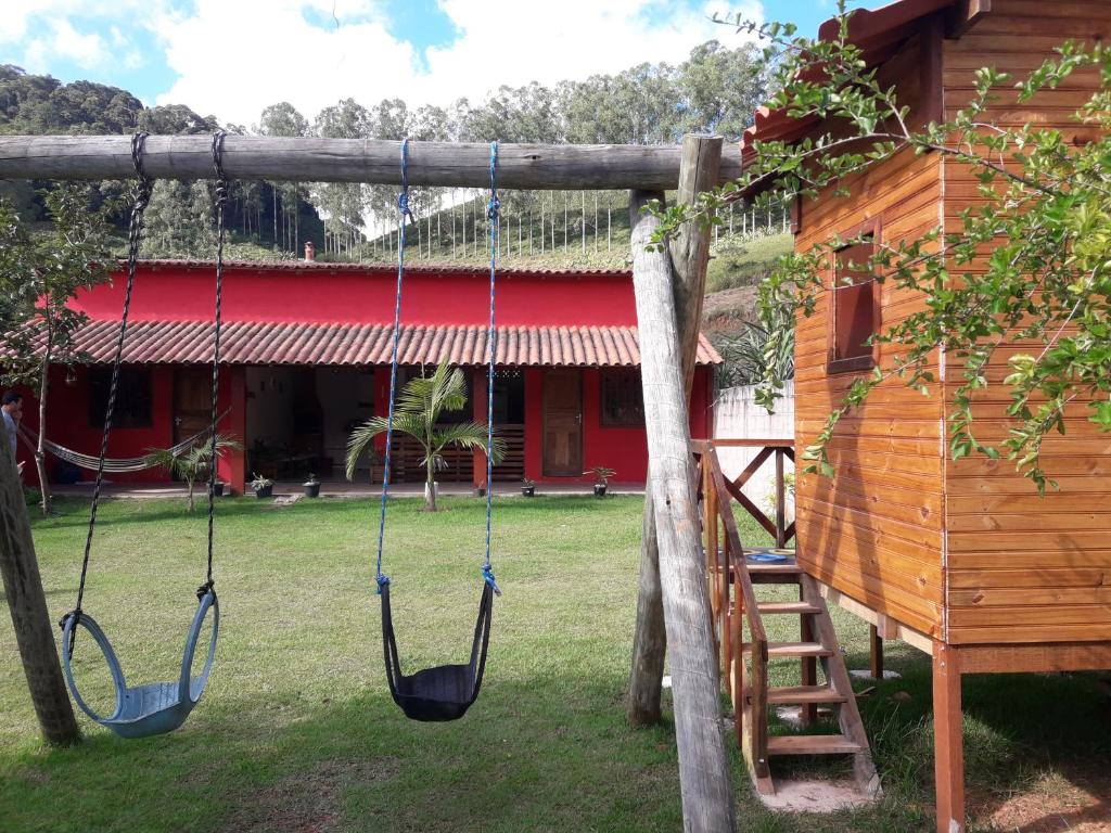 two swings in front of a log cabin at Casa Matilde in Matilde