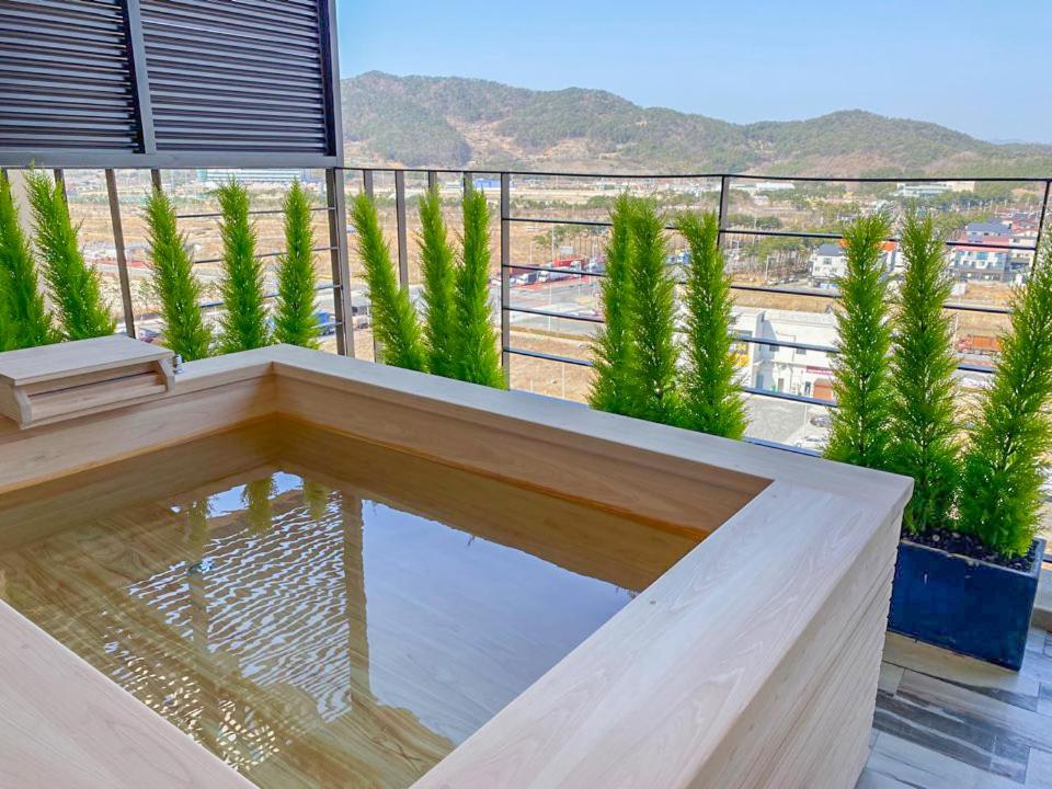 a balcony with a swimming pool on top of a building at Best Louis Hamilton Hotel West Busan in Busan