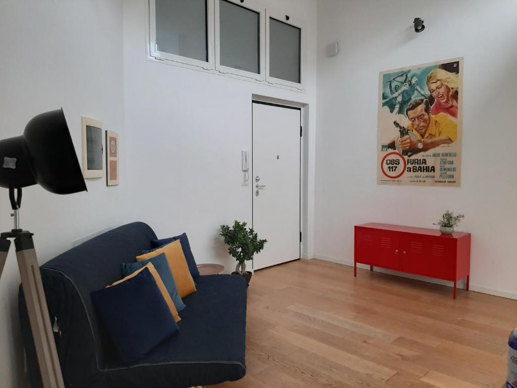 a living room with a blue couch and a red table at Turin Loft7 in Turin