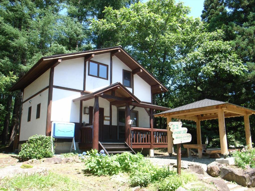 a small white house with a sign in front of it at Cottage All Resort Service / Vacation STAY 8419 in Inawashiro