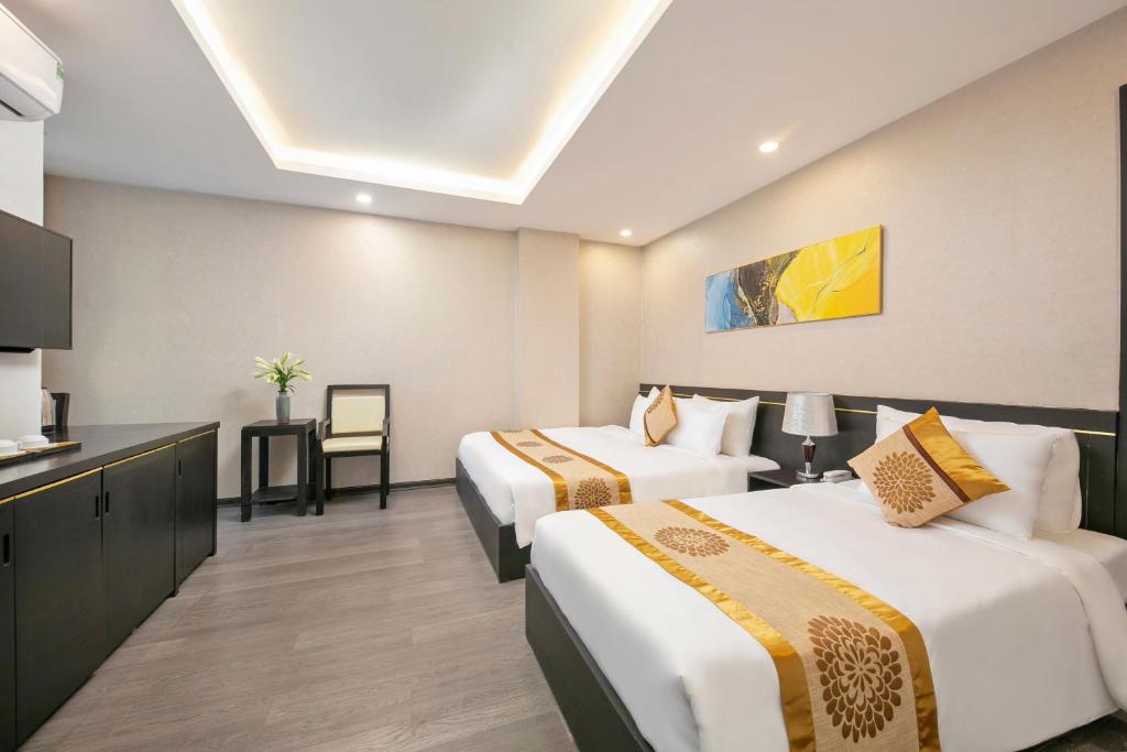 Postel nebo postele na pokoji v ubytování Hanami Hotel Danang