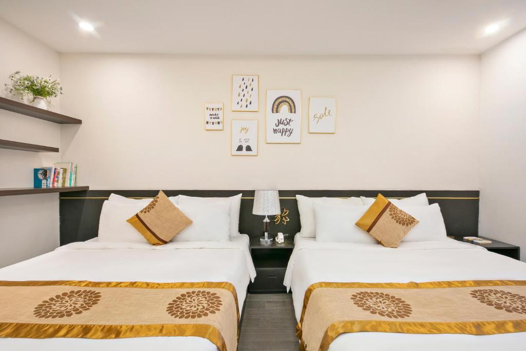 Postel nebo postele na pokoji v ubytování Hanami Hotel Danang
