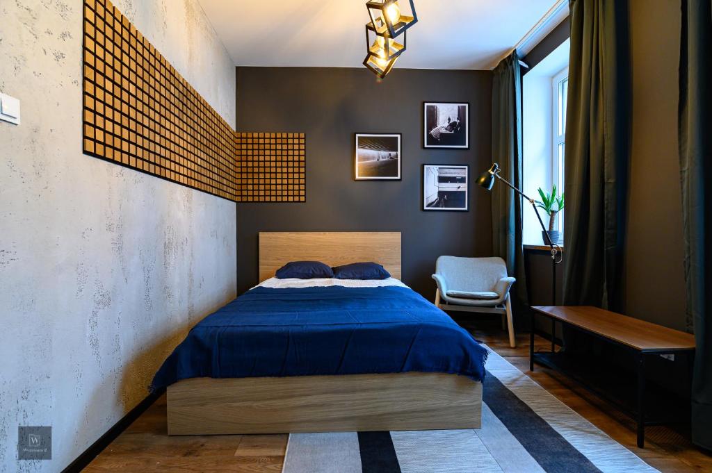 Posteľ alebo postele v izbe v ubytovaní Apartamenty Wyszyńskiego 2