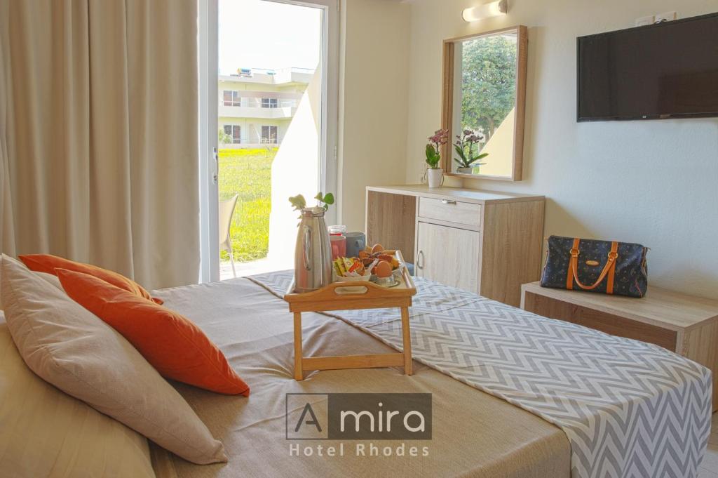 a bedroom with a bed with a table on it at Amira Hotel Rhodes in Rhodes Town