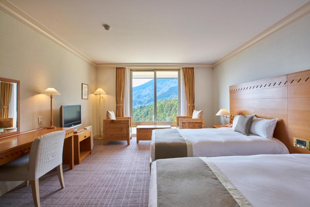 Postel nebo postele na pokoji v ubytování L'Hotel de Hiei