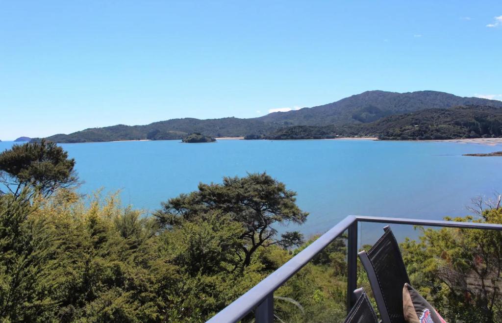 a view of a lake from a balcony at Poppy Apartment in Coromandel Town
