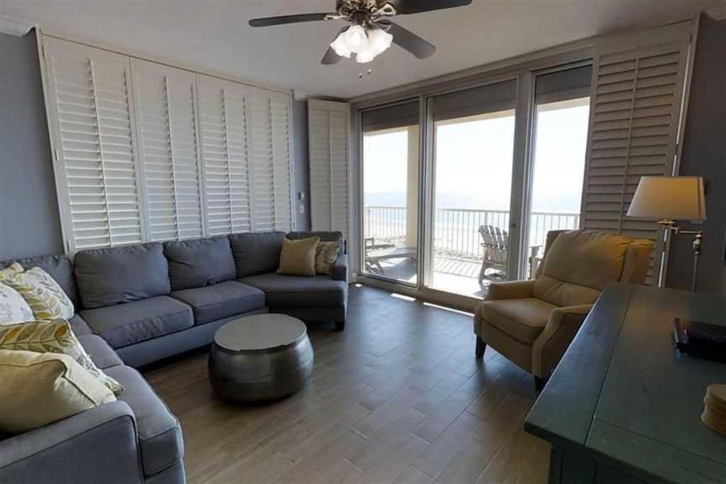 a living room with a couch and chairs and a table at The Beach Club Resort and Spa IV in Gulf Highlands