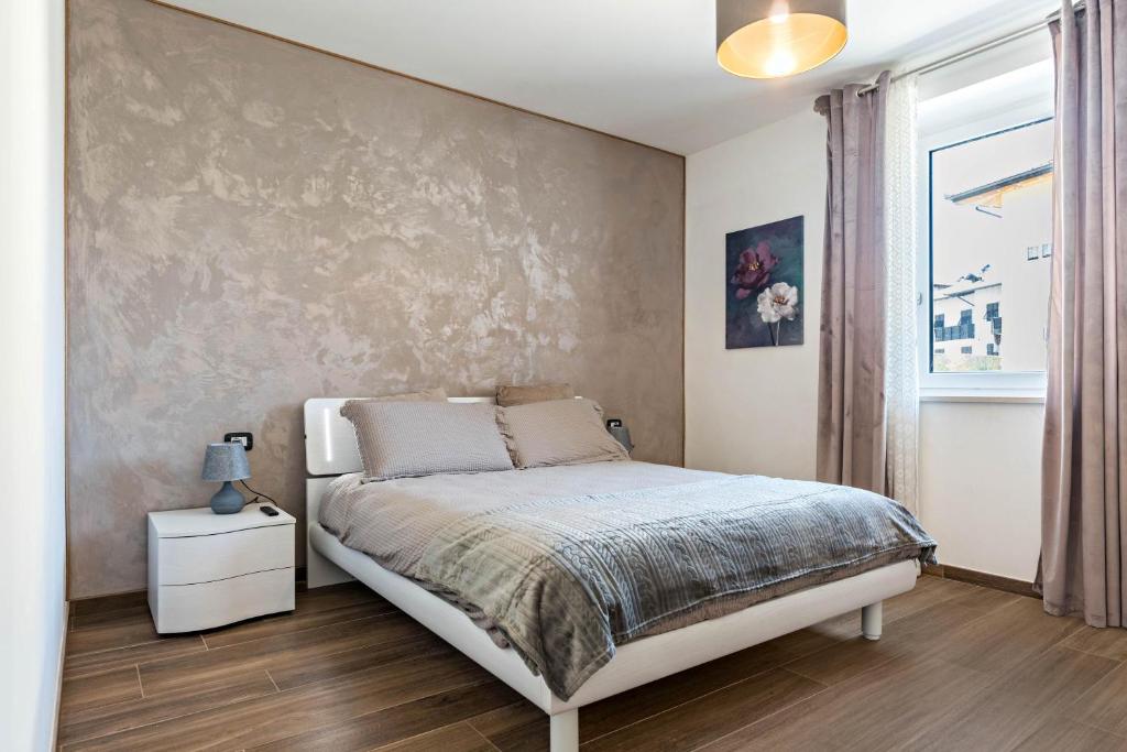 a bedroom with a bed and a wall at Villa Vacanze Renetta in Tuenno
