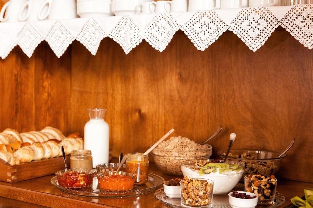a table with bread and other food items on it at Egli Hotel in Andros