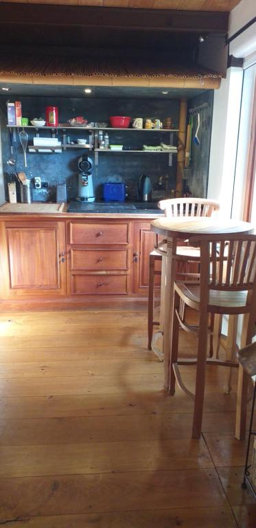 a kitchen with a wooden table and a table and chairs at Villa Blanco in Opwijk