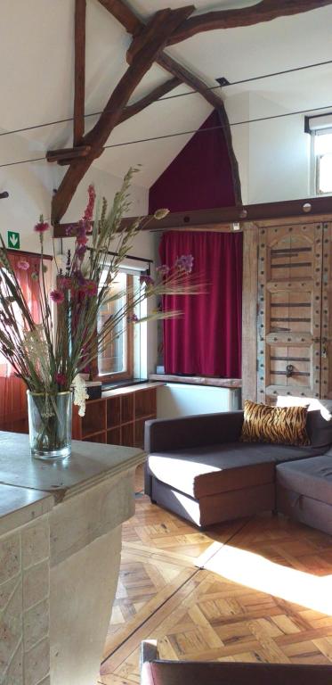 a living room with a large bed and a table at Villa Blanco in Opwijk