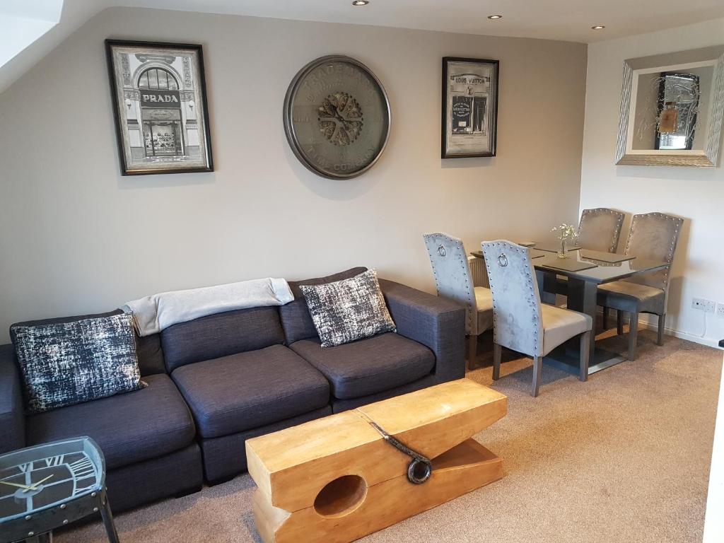 a living room with a couch and a table at Bowness On Windermere, Lovely Apartment for 4 With Parking in Bowness-on-Windermere