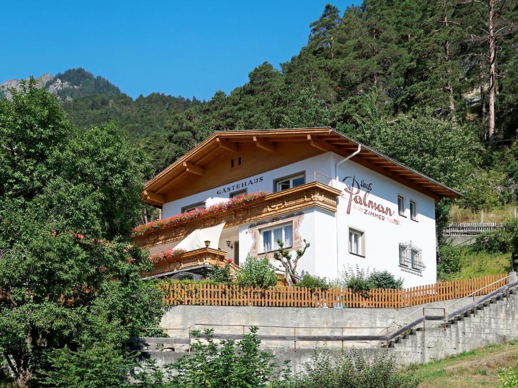 a house in the mountains with a fence at Holiday Home Palman - PFD160 by Interhome in Pfunds