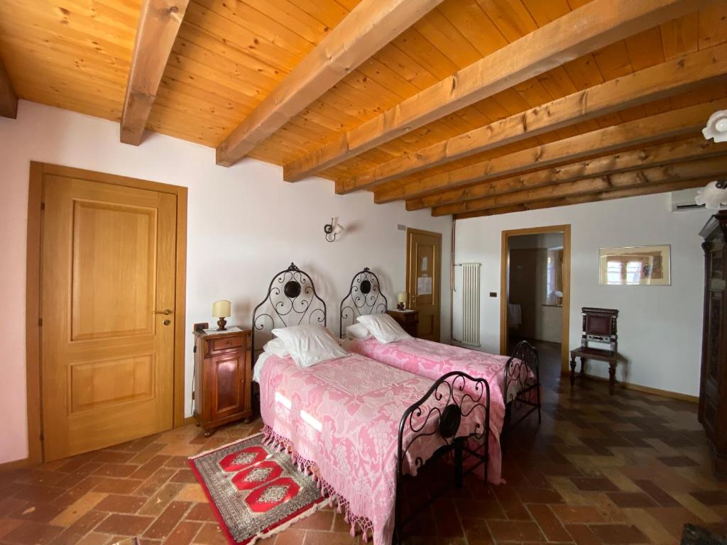 Postel nebo postele na pokoji v ubytování All'Antica Scuderia Del Castello