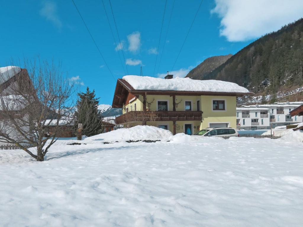 a house with snow on the ground in front of it at Apartment Faulhaber - PET130 by Interhome in Pettneu am Arlberg