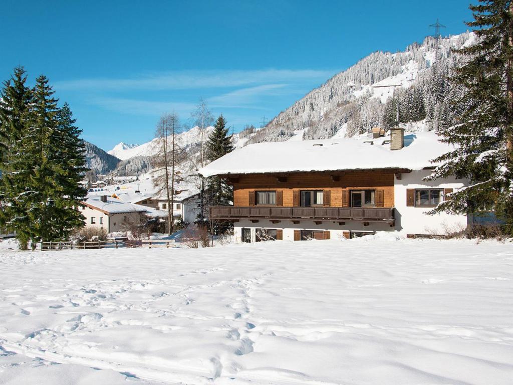 a house in the snow with footprints in the snow at Apartment Schuler - STA121 by Interhome in Nasserein