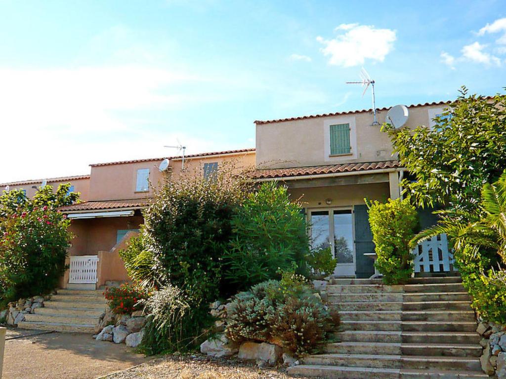 a house with stairs in front of it at Holiday Home Les Sentolines by Interhome in Saint Pierre La Mer