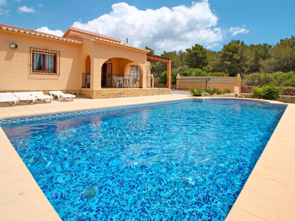 a swimming pool in front of a villa at Holiday Home Roque by Interhome in Calpe