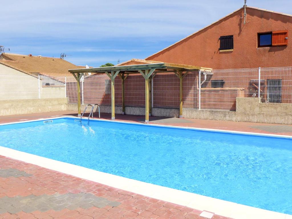 a swimming pool with a gazebo next to a house at Holiday Home L'Hacienda by Interhome in Narbonne-Plage