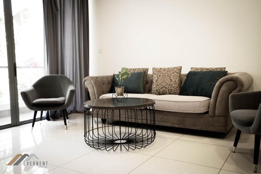 a living room with a couch and a table at Marina Times Square Homestay by Evernent in Miri