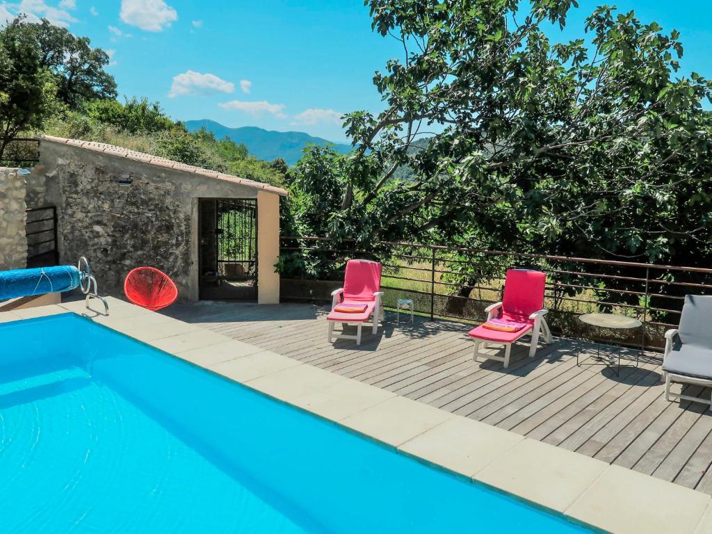 a villa with a swimming pool and two chairs at Holiday Home Chaud'abri - NYS170 by Interhome in Venterol