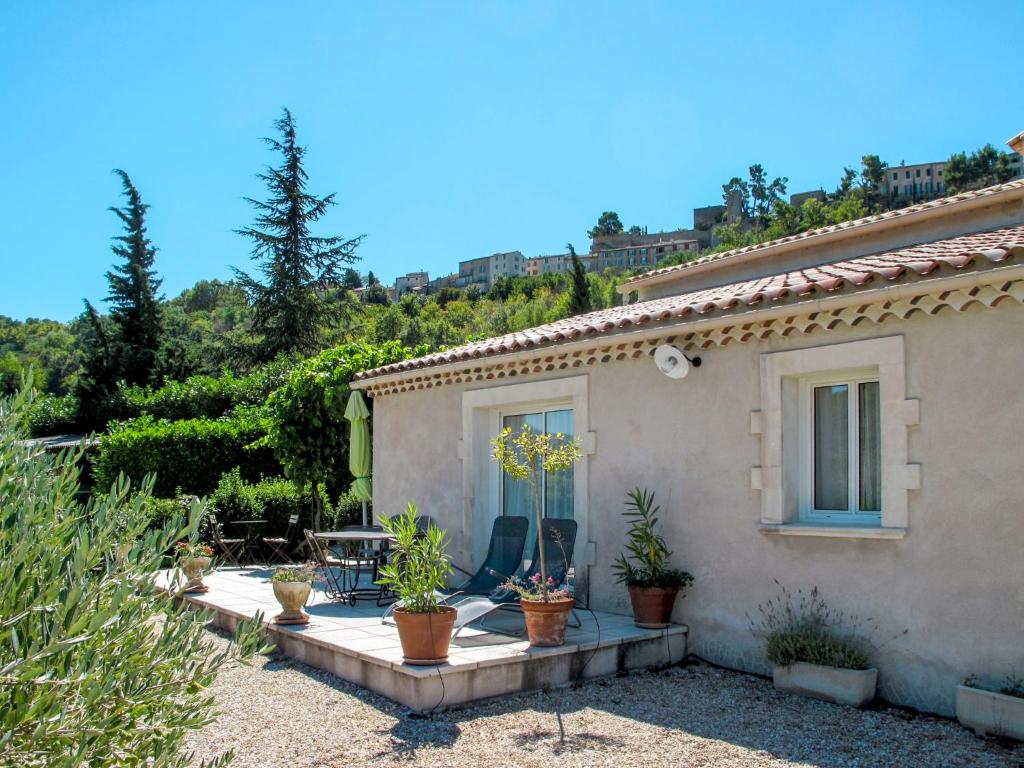 a house with potted plants in front of it at Holiday Home Les Vignes - MBE100 by Interhome in Ménerbes
