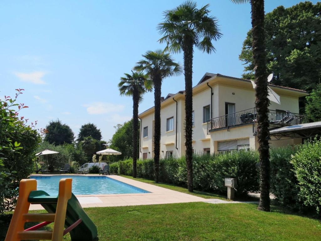 uma villa com piscina e palmeiras em Apartment del Sole-3 by Interhome em Luino