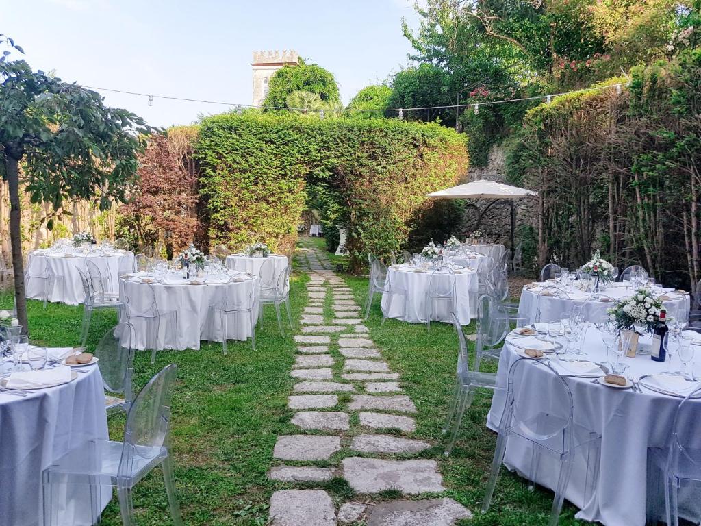 a table set up for a wedding with white tables and chairs at Apartment Morgana - FLG208 by Interhome in Finale Ligure