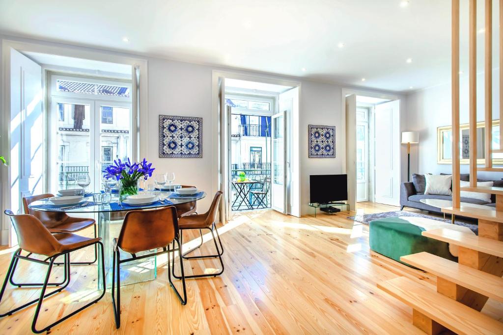 a living room with a table and chairs and a couch at Life is Good in Lisbon Baixa in Lisbon