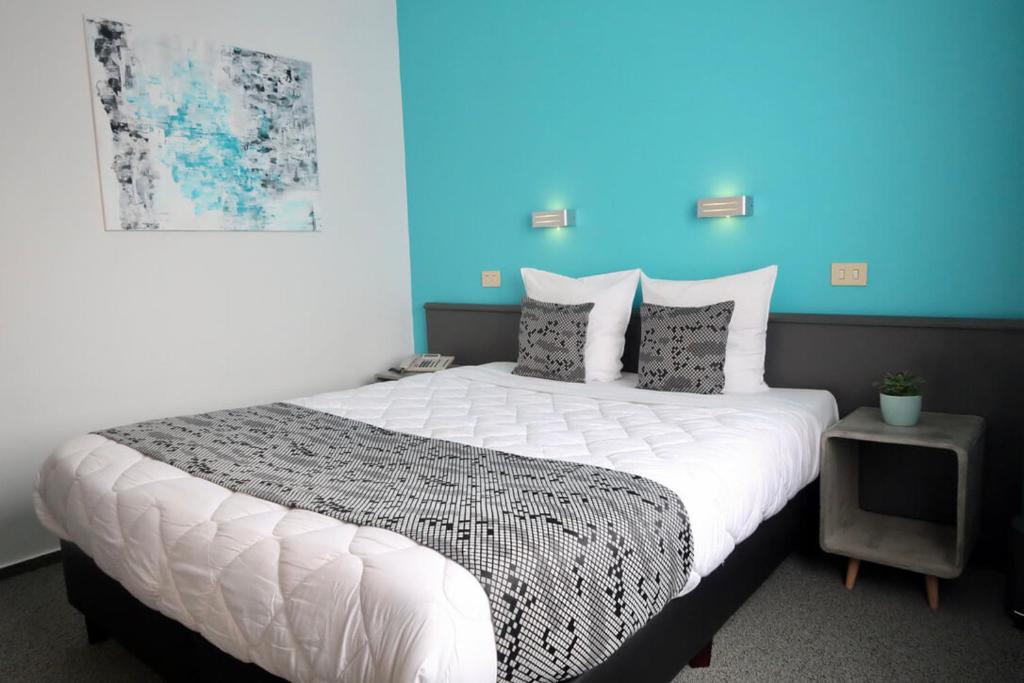 Postel nebo postele na pokoji v ubytování Hotel Adoma