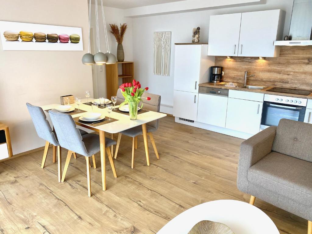 a kitchen and dining room with a table and chairs at mönchgut living & spa in Gager