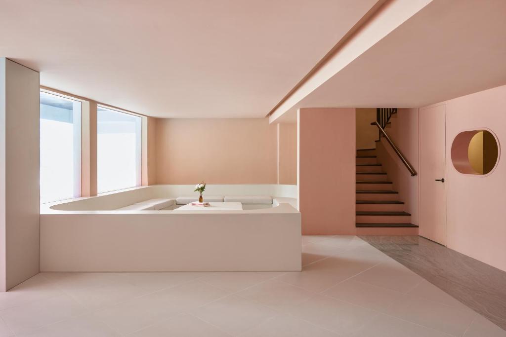 a room with a bath tub and a staircase at KINN Capsule in Singapore