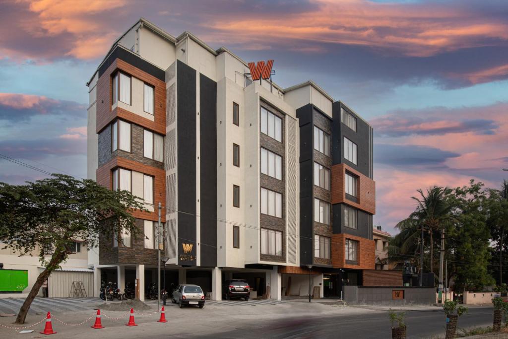 a large building with orange cones in front of it at Windstone Residency in Coimbatore
