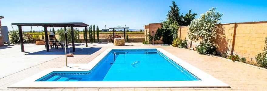 a swimming pool in a backyard with at Casa Rural Villa Paquita in La Lantejuela