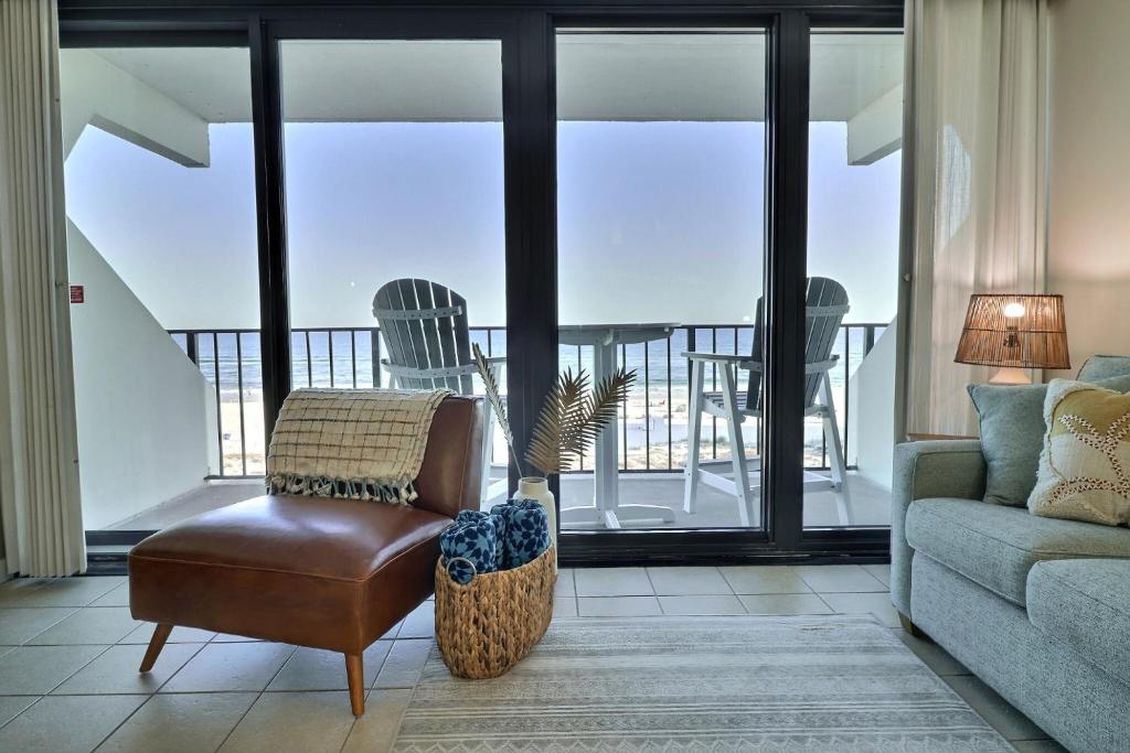 a living room with a chair and a couch at Island Winds East in Gulf Shores