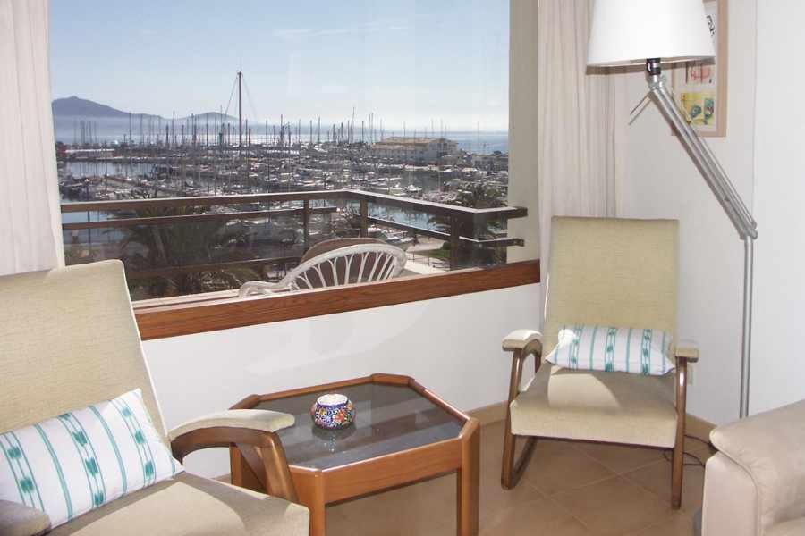 a living room with a view of a city at Apartamento en primera linea para 4 personas in Port de Pollensa