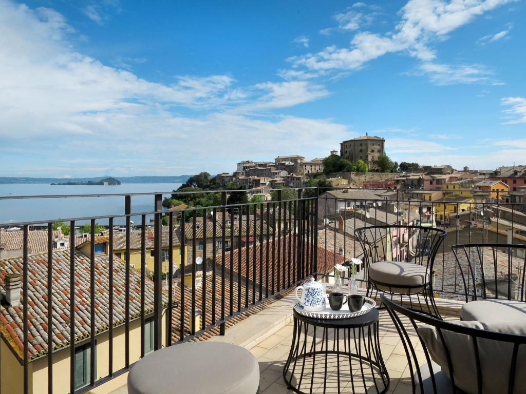 a balcony with chairs and a view of the water at Holiday Home Mimmina by Interhome in Capodimonte