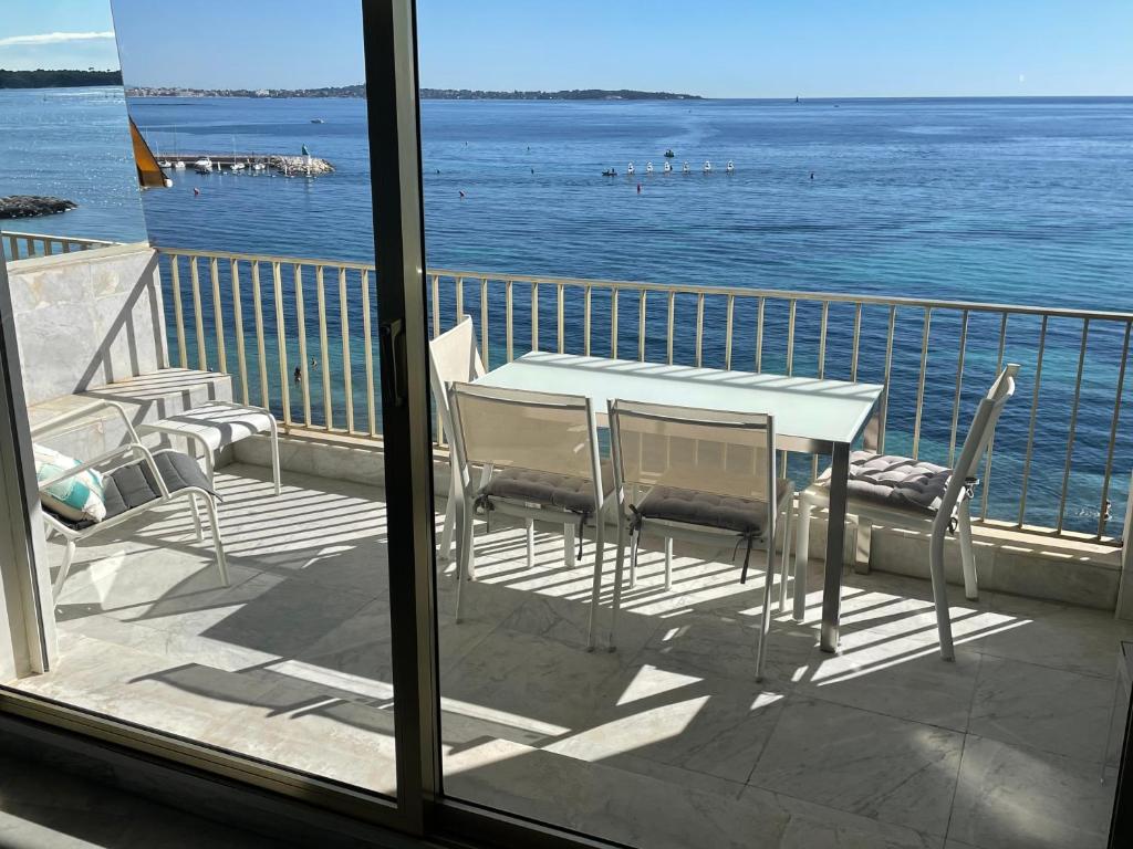 a table and chairs on a balcony overlooking the water at Palm Beach Amazing view in Cannes