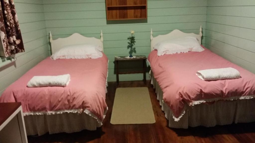 two beds sitting next to each other in a room at The Whare Rural Retreat in Hastings