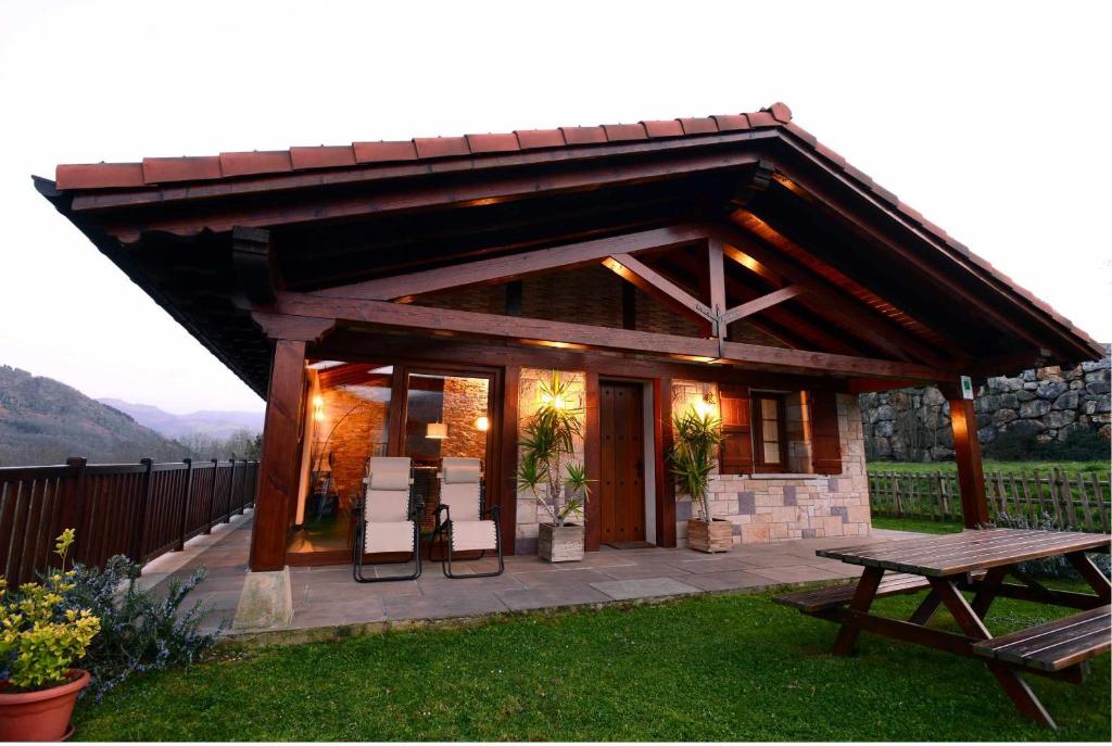 a small house with a table and a picnic table at Casa Angiz etxea in Sumbilla