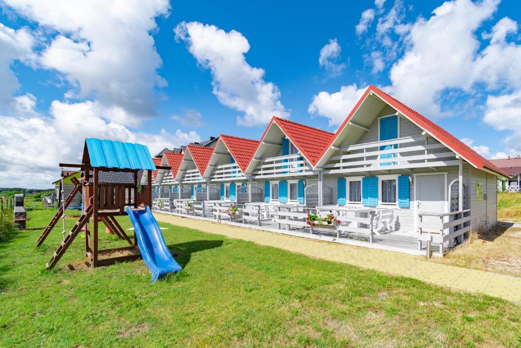 a row of houses with a slide and a playground at Marina in Jarosławiec
