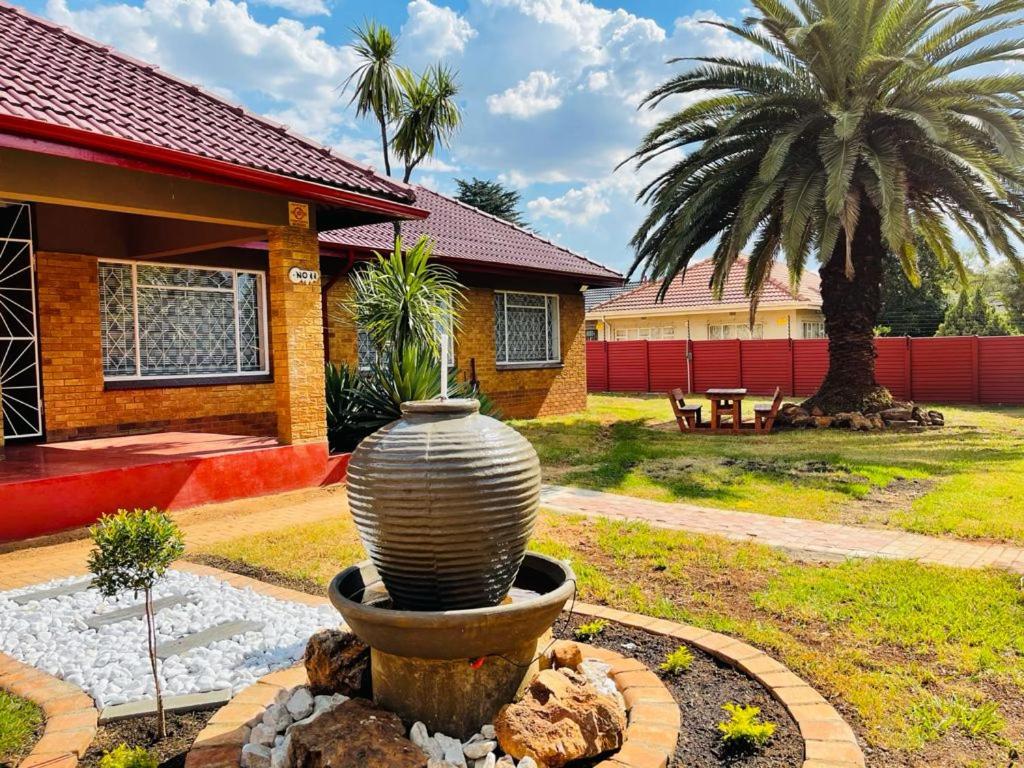 a large vase in front of a house at Ithonsi Guesthouse and Spa in Kempton Park