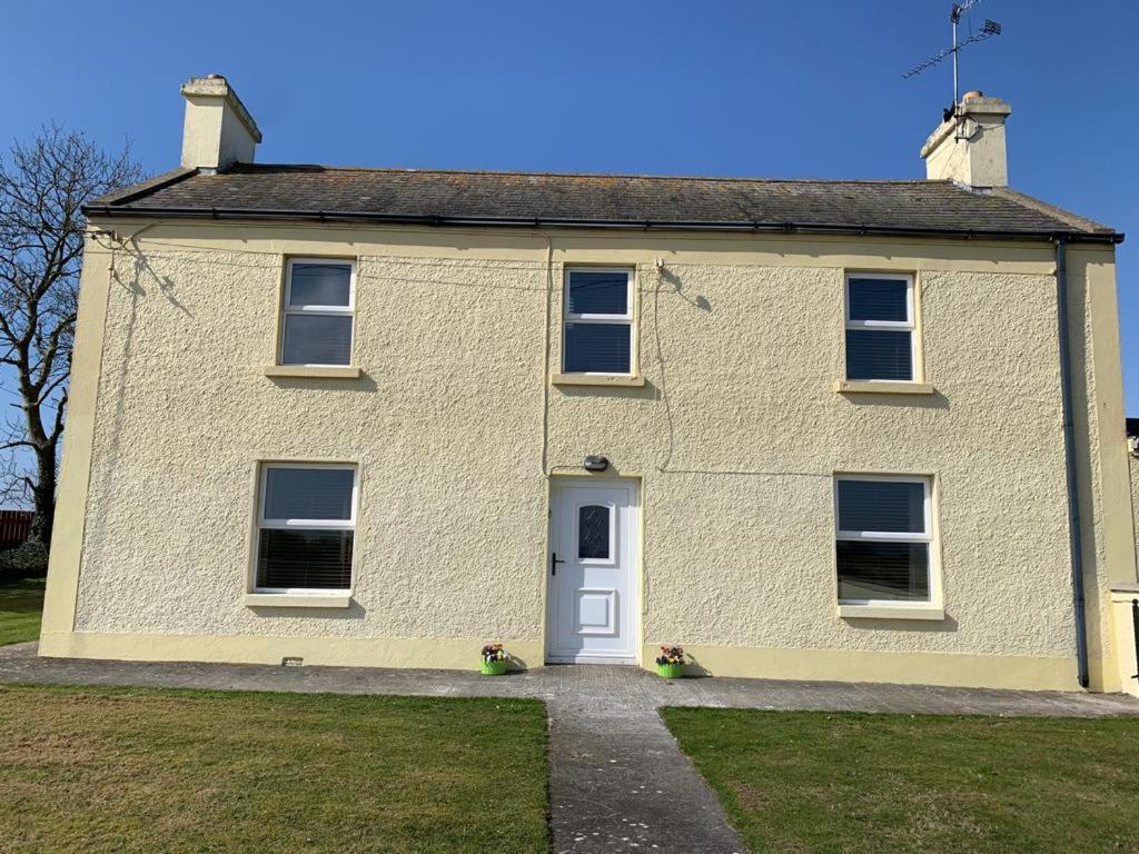 a large white brick house with a white door at Granda's House - A Home from Home near Carlingford in Carlingford