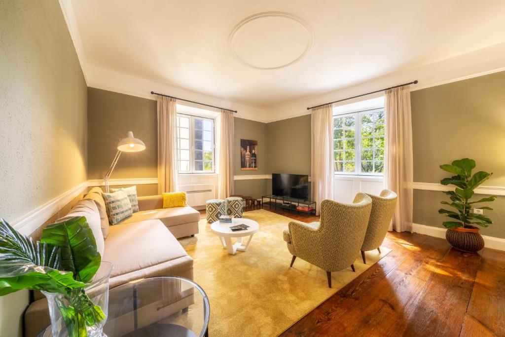 a living room with a couch and chairs at The Wine Lodges in Funchal